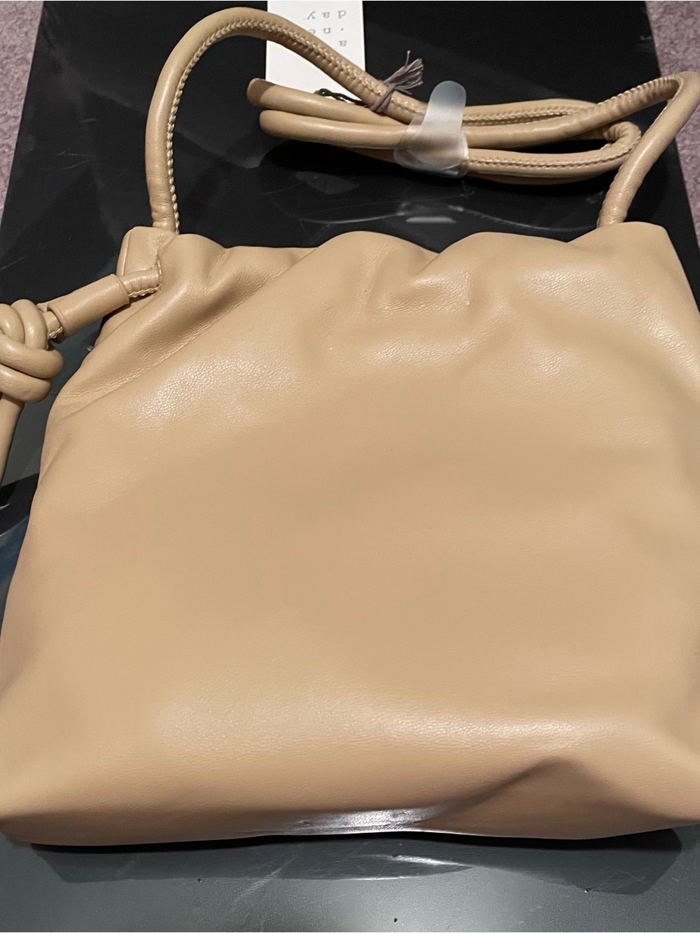A New Day slouchy beige shoulder bag features a cinched drawstring closure with